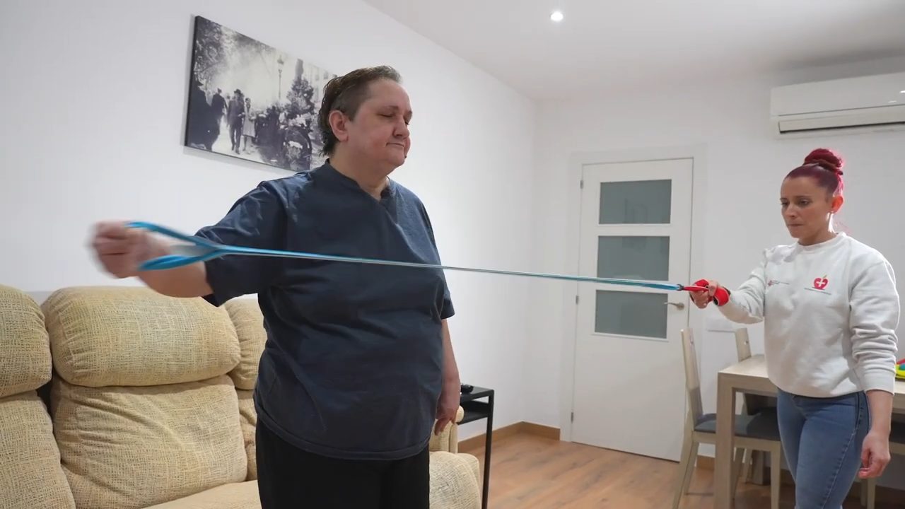 Paciente realizando ejercicios de rehabilitación neurológica con una fisioterapeuta en su domicilio en Barcelona